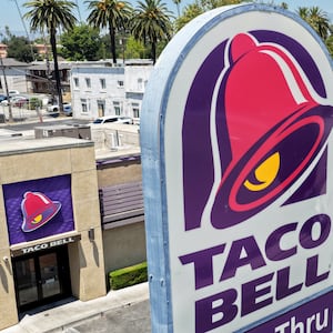PASADENA, CALIFORNIA - JULY 14: In an aerial view, customers depart a Taco Bell restaurant on July 14, 2026 in Pasadena, California. Federal and state health officials have reportedly begun investigating whether lettuce served at some Taco Bell restaurants has led to the widespread outbreak of cyclosporiasis, a gastrointestinal illness, which has sickened thousands around the country. (Photo by Mario Tama/Getty Images)