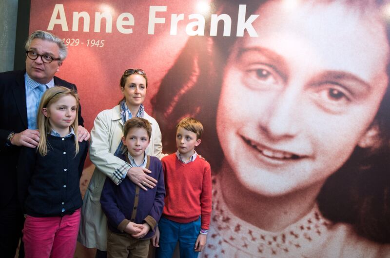 Prince Laurent of Belgium (L) his wife Princess Claire of Belgium (C) and their children (from L) Princess Louise, Prince Aymeric and Prince Nicolas pose during a royal visit to the exhibition "La maison d'Anne Frank" (Anne Frank House) in Stavelot on April 20, 2015.