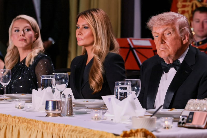 U.S. President Donald Trump and first lady Melania Trump, next to White House Press Secretary Karoline Leavitt, attend the annual White House Correspondents' Association dinner