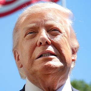President Donald Trump speaks in front of the American flag to the press as he departs the White House on May 12, 2026 in Washington, DC.