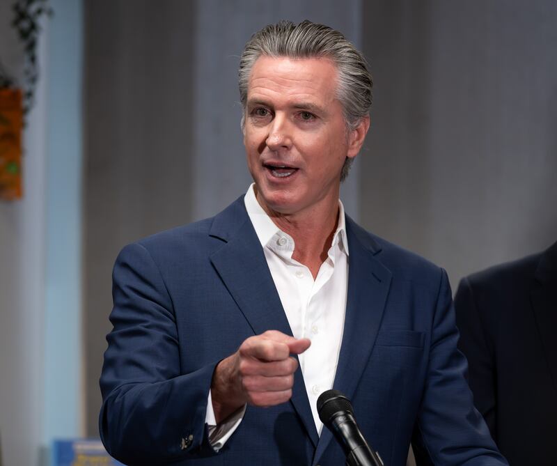 Governor Gavin Newsom speaks to the media during a signing of Bill AB1454