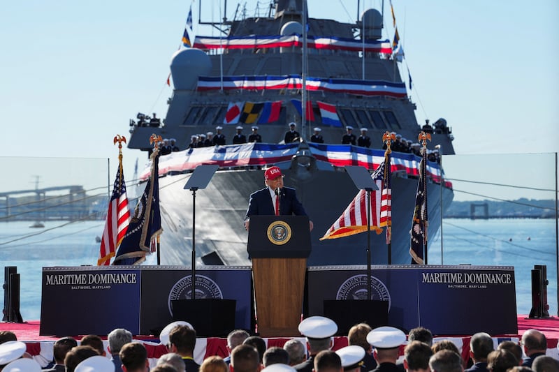 US Navy members listen to Trump speak at Sparrows Point Shipyard, as the USS Billings sits in the background. Defense tech firm Anduril unveiled plans for a $3.7 billion ‌shipyard there.