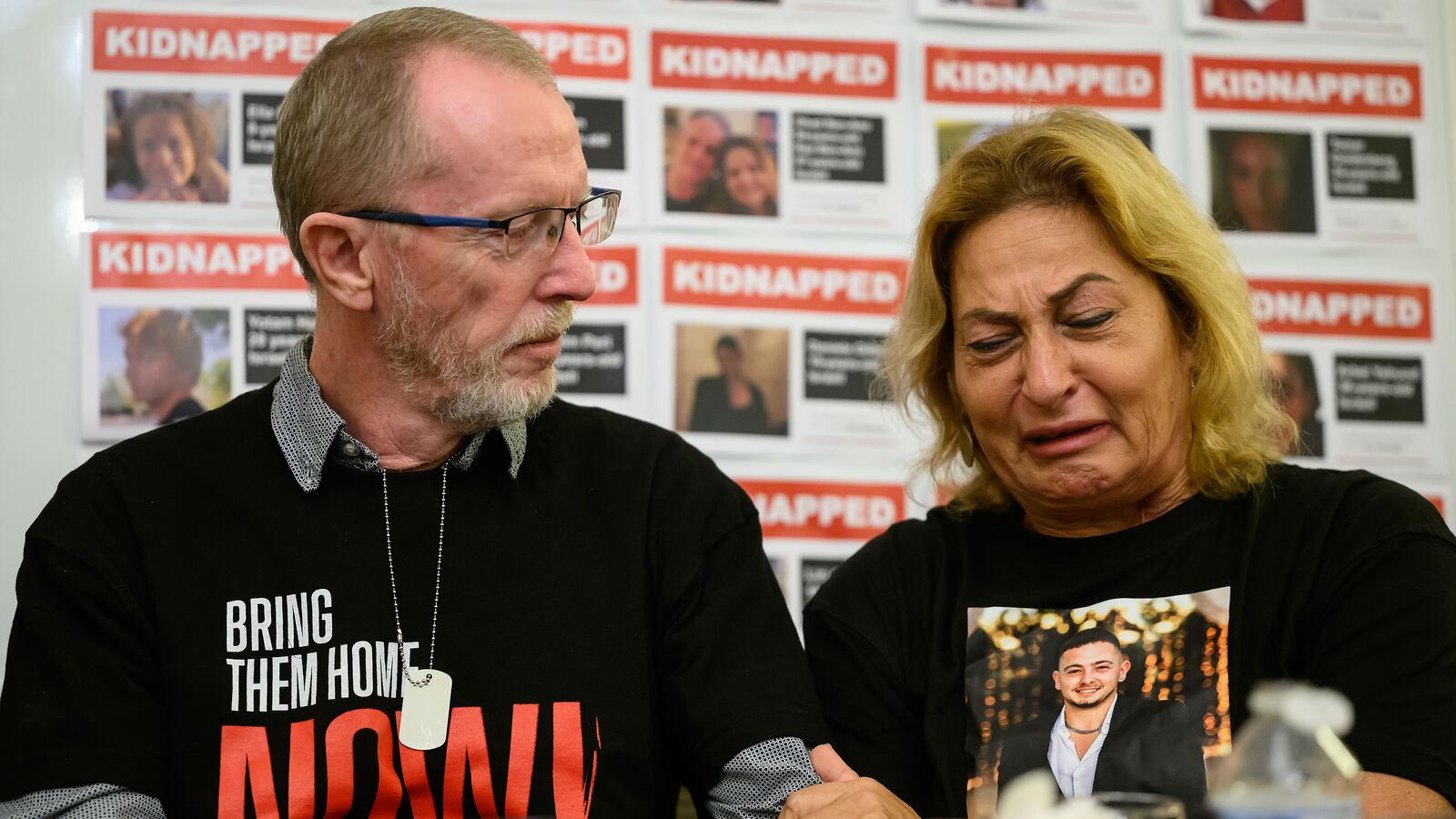 Thomas Hand, left, the father of Emily Hand, listens to Orit Meir, the mother of Almog Meir, as she addresses journalists during a press conference at the Embassy of Israel, London, on November 20, 2023.