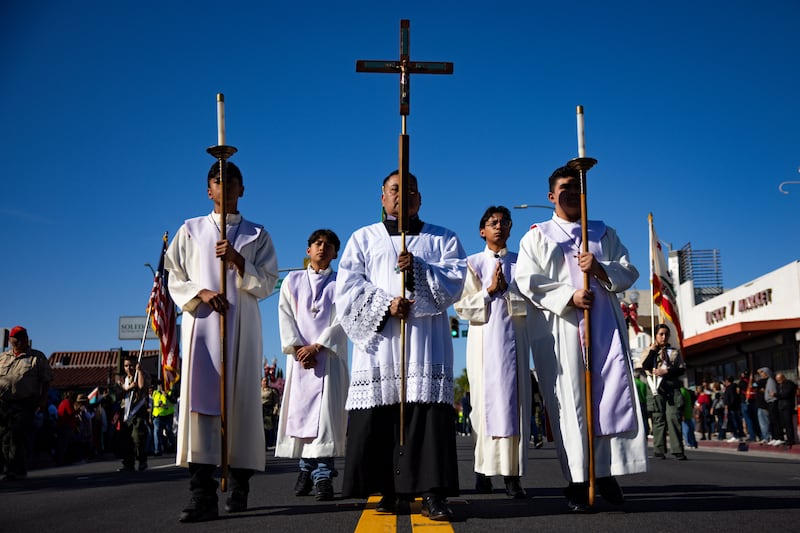 East Los Angeles, CA - December 07: Participants walk in annual tour of the pilgrim images of Our Lady of Guadalupe and St. Juan Diego down East Cesar Chavez Avenue on Sunday, Dec. 7, 2025 in East Los Angeles, CA. The pilgrimage of the images of Our Lady of Guadalupe and St. Juan Diego concluded 51 parishes hosting the images during the 94th annual Procession and Mass. (Kayla Bartkowski / Los Angeles Times via Getty Images)