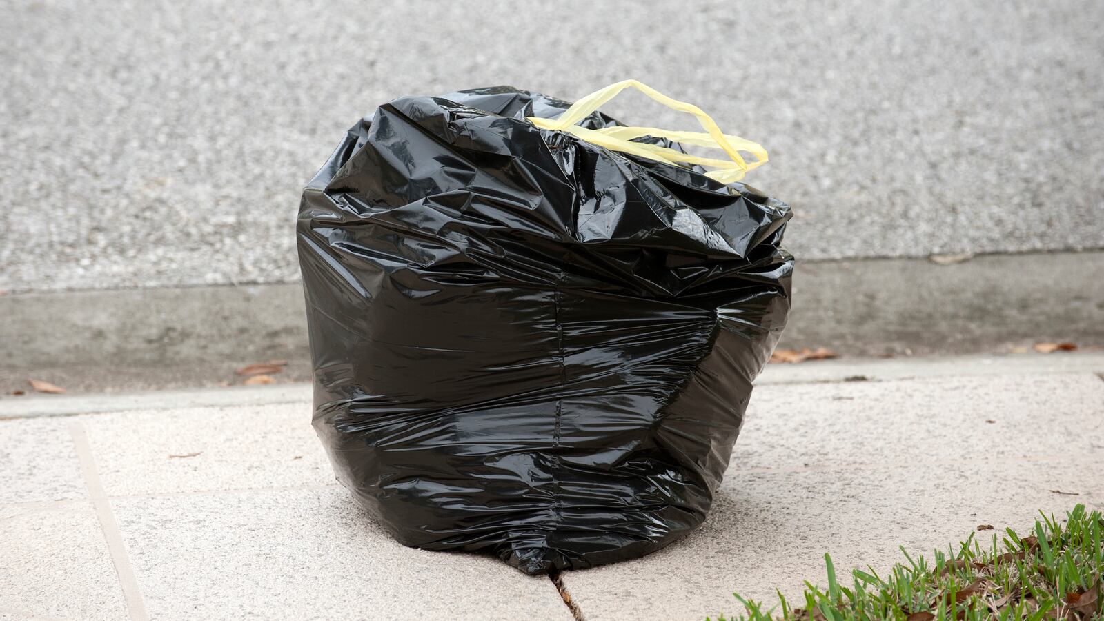 Refuse bag at roadside awaiting collection.