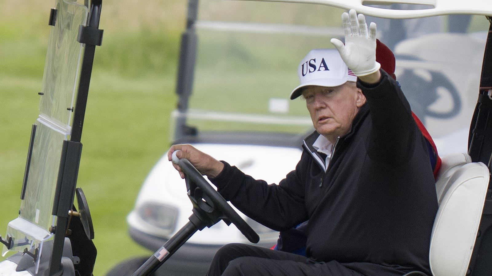 US President Donald Trump waves while in a golf cart at his Trump Turnberry golf course in South Ayrshire, during his five-day private trip to the country. Picture date: Sunday July 27, 2025. (Photo by Jane Barlow/PA Images via Getty Images)