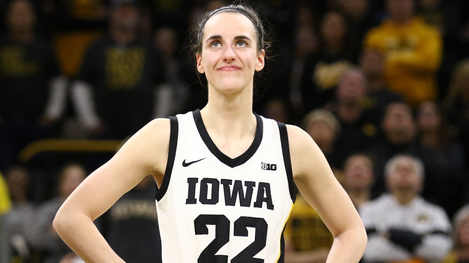 Guard Caitlin Clark #22 of the Iowa Hawkeyes listens as the crowd cheers after breaking the NCAA women's all-time scoring record during the game against the Michigan Wolverines at Carver-Hawkeye Arena on February 15, 2024 in Iowa City, Iowa.