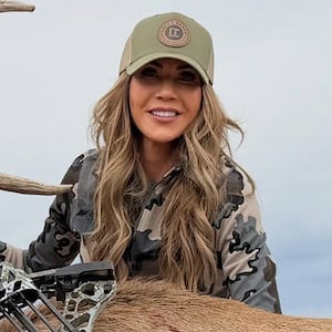Former Homeland Security secretary Kristi Noem poses with the elk she killed.