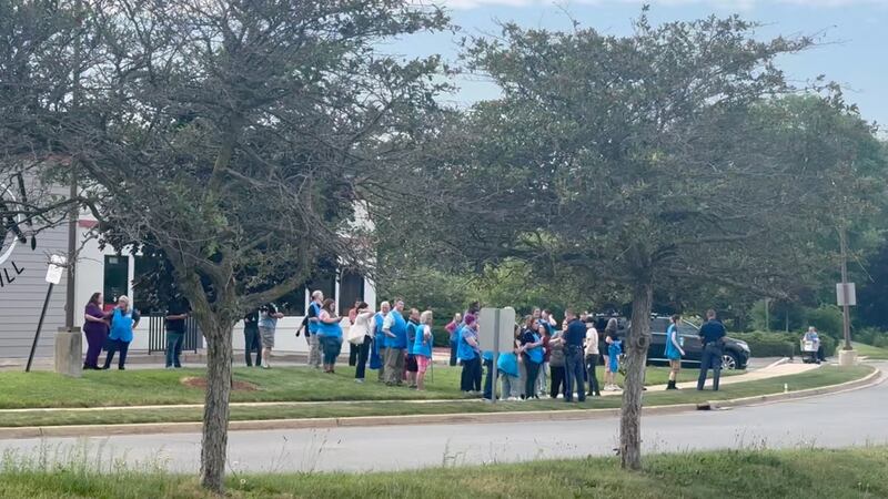 Police officers speak to Walmart employees following a mass stabbing incident in Traverse City, Michigan.