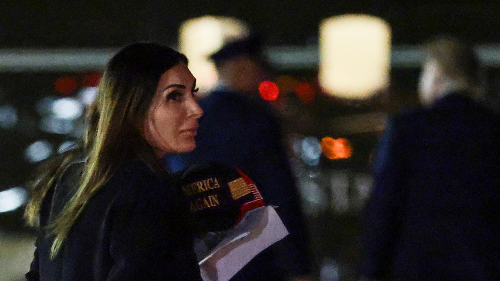 JOINT BASE ANDREWS, MARYLAND - OCTOBER 02: Political activist Laura Loomer follows behind U.S. President Donald Trump as he walks off Air Force One on October 02, 2026 in Joint Base Andrews, Maryland. Trump travelled to Mobile, Alabama for a campaign rally. (Photo by Anna Moneymaker/Getty Images)