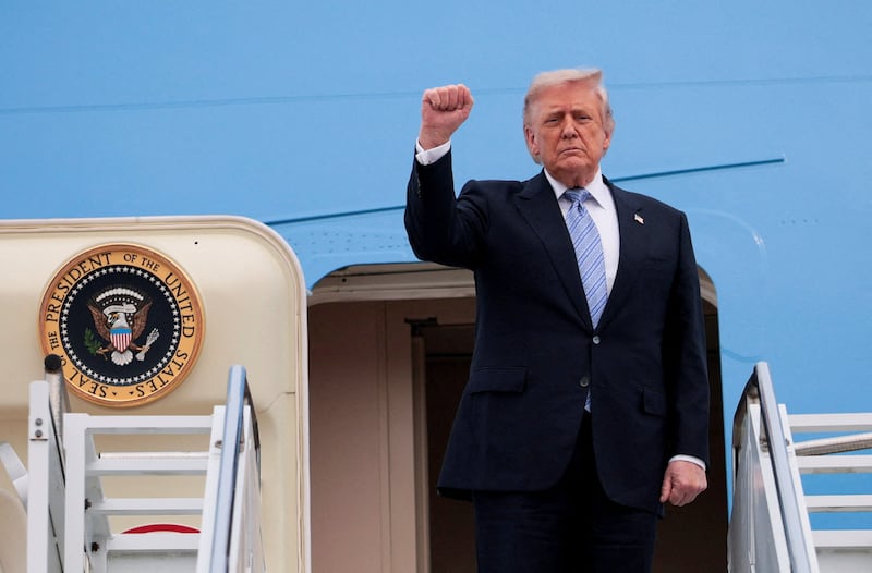 U.S. President Donald Trump gestures as he departs Beijing Capital International Airport aboard Air Force One, in Beijing, China, May 15, 2026.