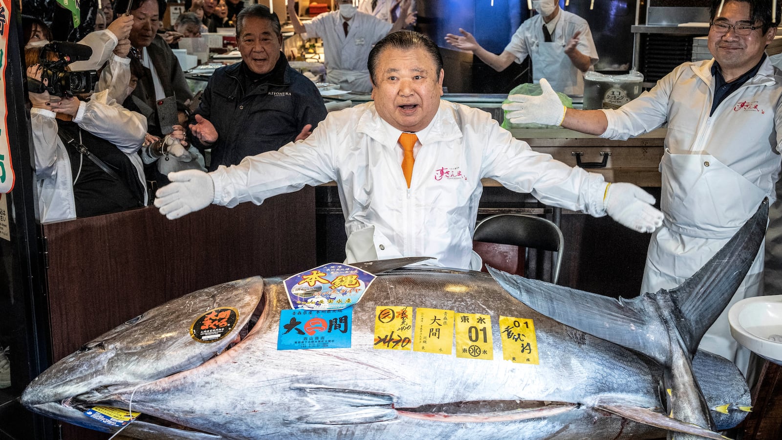 Kiyoshi Kimura (C), president of Kiyomura Corp., the Tokyo-based operator of sushi restaurant chain Sushizanmai, displays a 243-kilogram bluefin tuna at his main restaurant in Tokyo on January 5, 2026, after the New Year's auction at Toyosu fish market. A Japanese sushi entrepreneur paid a record $3.2 million for a giant bluefin tuna January 5 at an annual prestigious new year auction in Tokyo's main fish market, smashing the previous all-time high. (Photo by Yuichi YAMAZAKI / AFP via Getty Images)