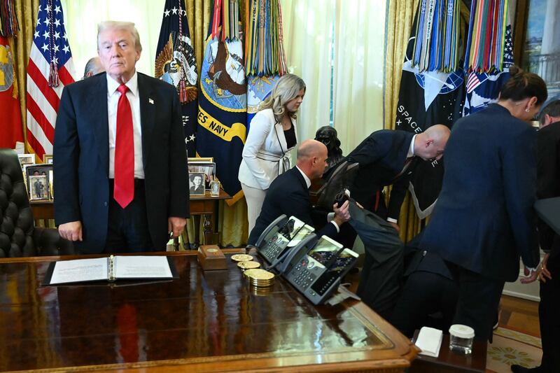 Trump looks on after a man fainted during his announcement about weight-loss drugs in the Oval Office.