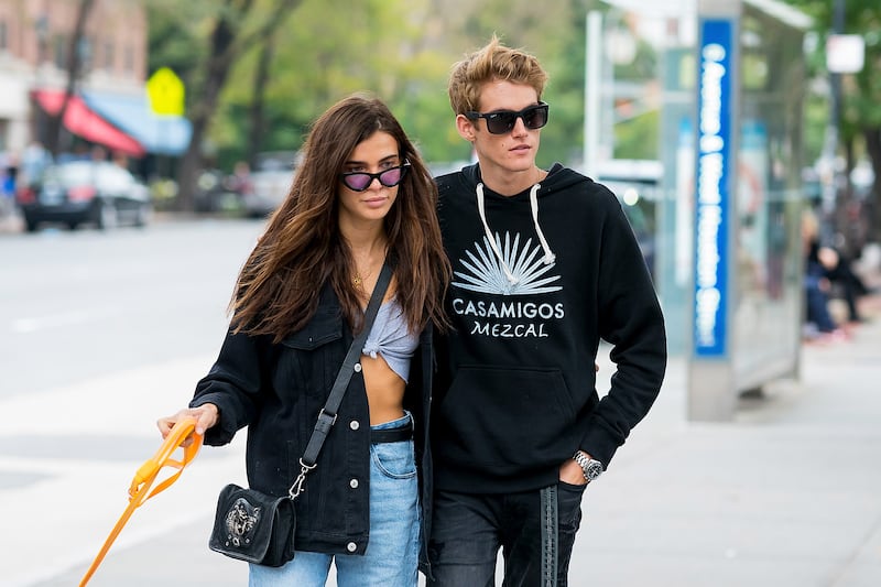 Presley Gerber and then-girlfriend Charlotte D'Alessio walking a dog together in New York City.