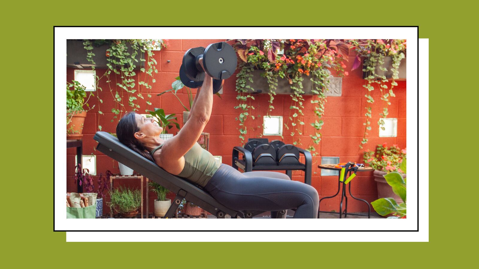 Woman doing dumbbell chest presses on the Johnson Fitness and Wellness adjustable bench.