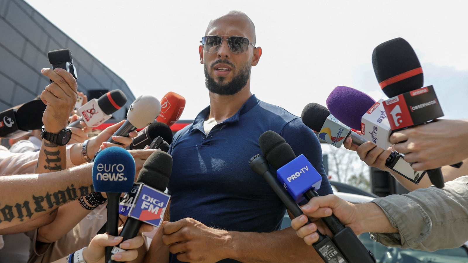 Andrew Tate delivers a press statement outside his house in Voluntari, Ilfov, Romania