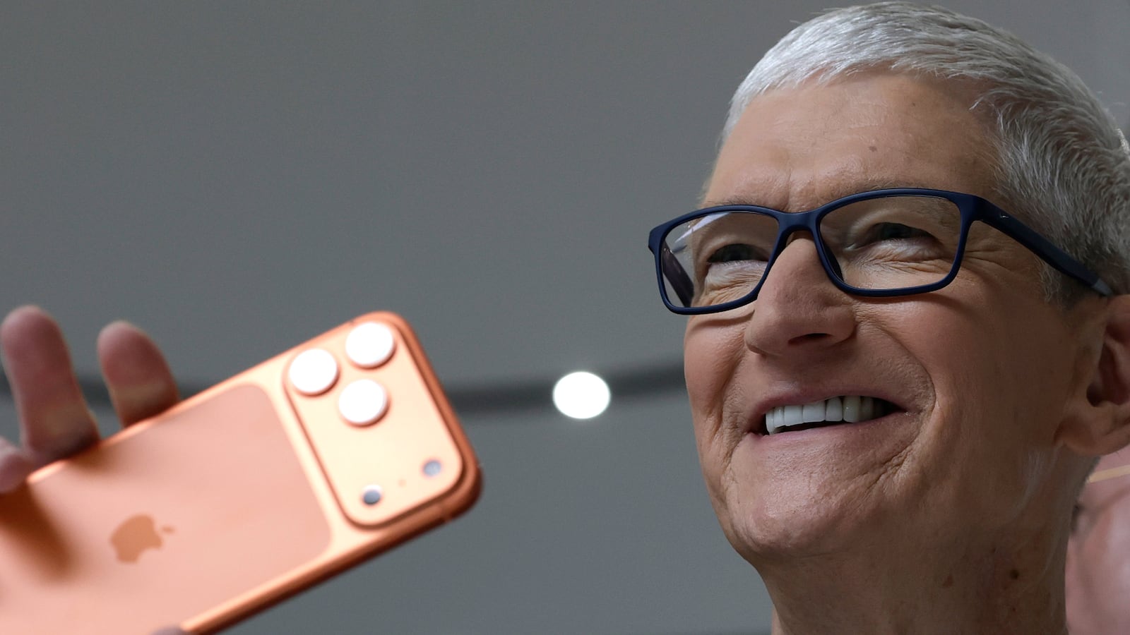 Tim Cook holds up a new iPhone 17 Pro.