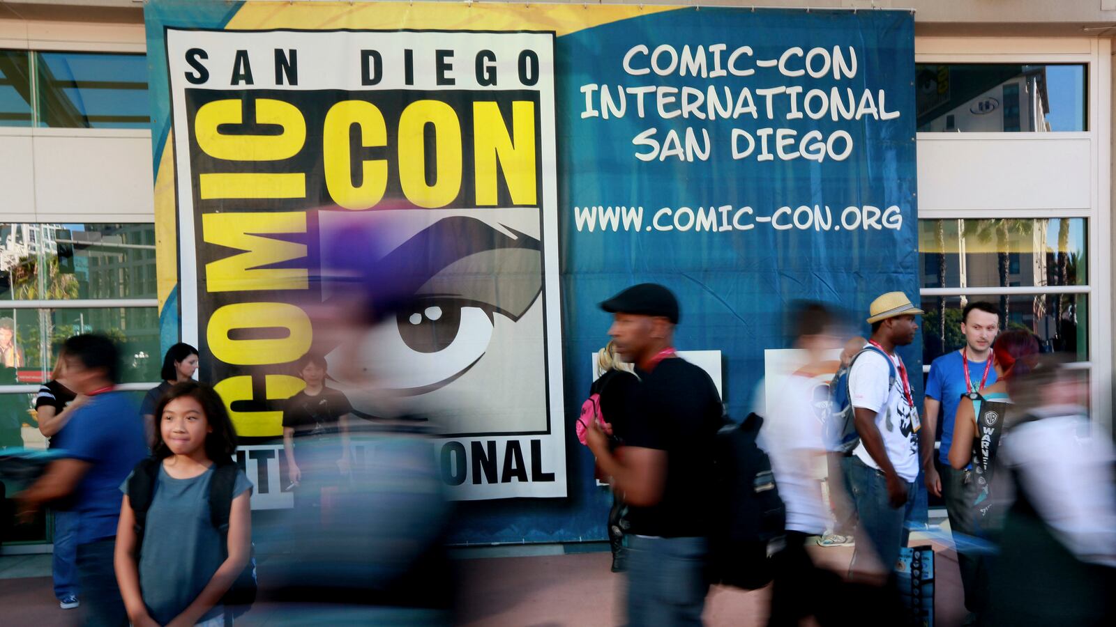 Attendees walk outside the Convention Center during the 2014 Comic-Con International Convention. A slew of studios and productions have canceled their panels at the upcoming 2023 San Diego Comic-Con now that the Screen Actors Guild is on strike.