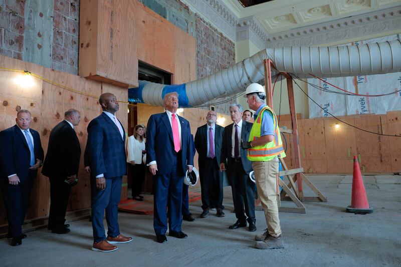 President Donald Trump with Federal Reserve Chair Jerome Powell, Sen. Tim Scott and other Trump officials tour the Federal Reserve’s $2.5 billion headquarters renovation project on July 24, 2025.