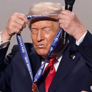 U.S. President Donald Trump places the medal on himself