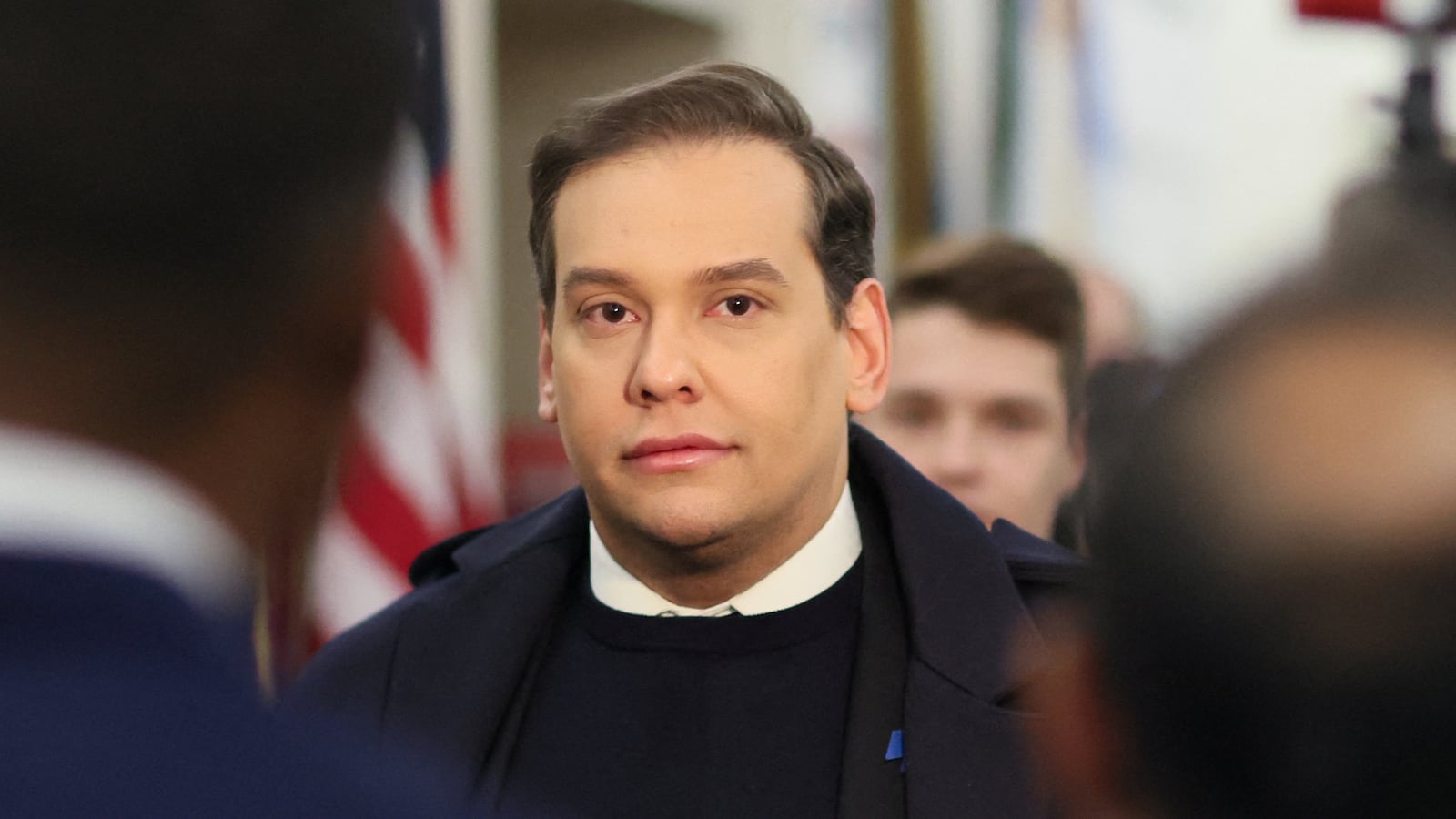 George Santos stares forward as he walks through the U.S. Capitol before a vote to expel him.