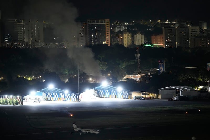 Smoke raises at La Carlota airport after explosions and low-flying aircraft were heard in Caracas, Venezuela, Saturday, Jan. 3, 2026.
