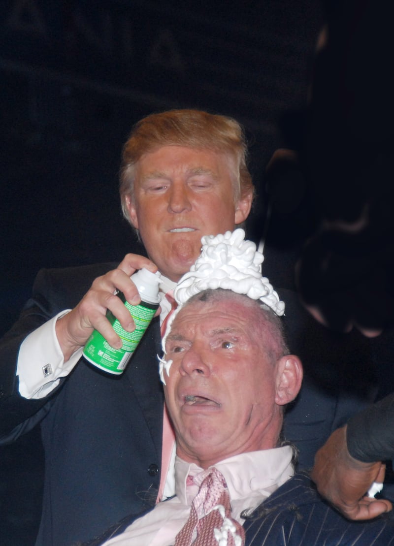 Donald Trump applies shaving creme to Vince McMahon's head after his mentor Bobby Lashley defeated Umaga in front of 80,103 fans in their "Battle of the Billionaires" match at Wrestlemania 23 in Ford Field in Detroit. (Photo by George Napolitano/FilmMagic)