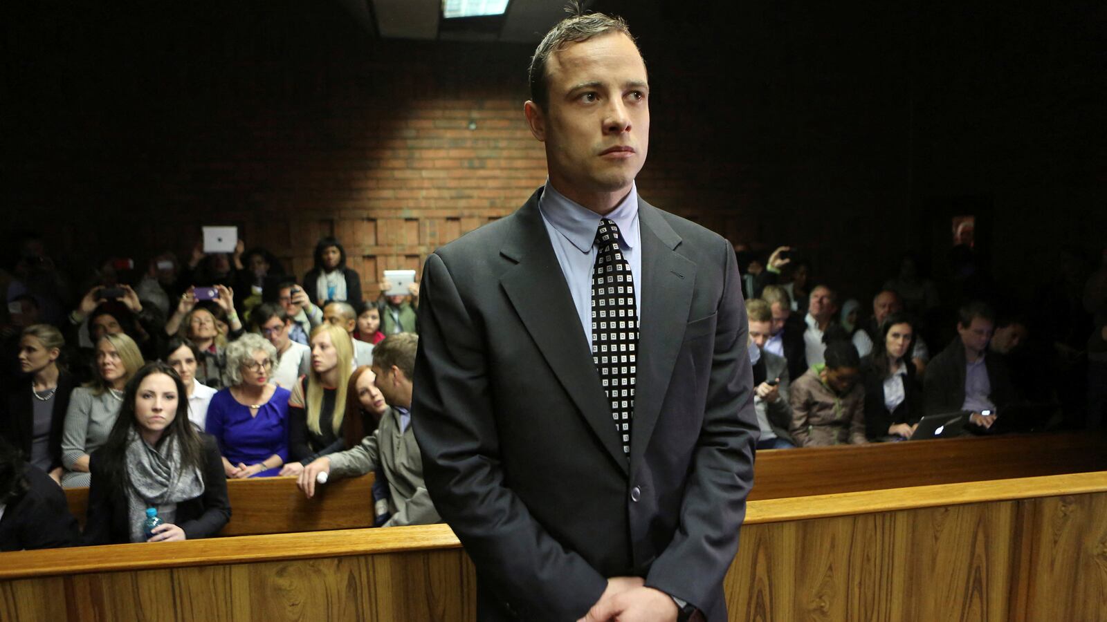 Oscar Pistorius enters the dock before court proceedings at the Pretoria Magistrates court June 4, 2013.