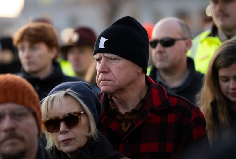 Minnesota Gov. Tim Walz (R) and his wife Gwen Walz (L) look on during a vigil for Renee Good on the steps of the state capitol building on January 09, 2026 in St. Paul, Minnesota.