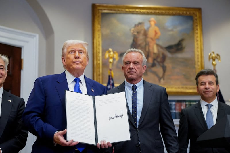 U.S. President Donald Trump holds an executive order on prescription drug pricing next to U.S. Health and Human Services (HHS) Secretary Robert F. Kennedy, Jr., during a press conference in the Roosevelt Room at the White House in Washington, D.C., U.S., May 12, 2025.