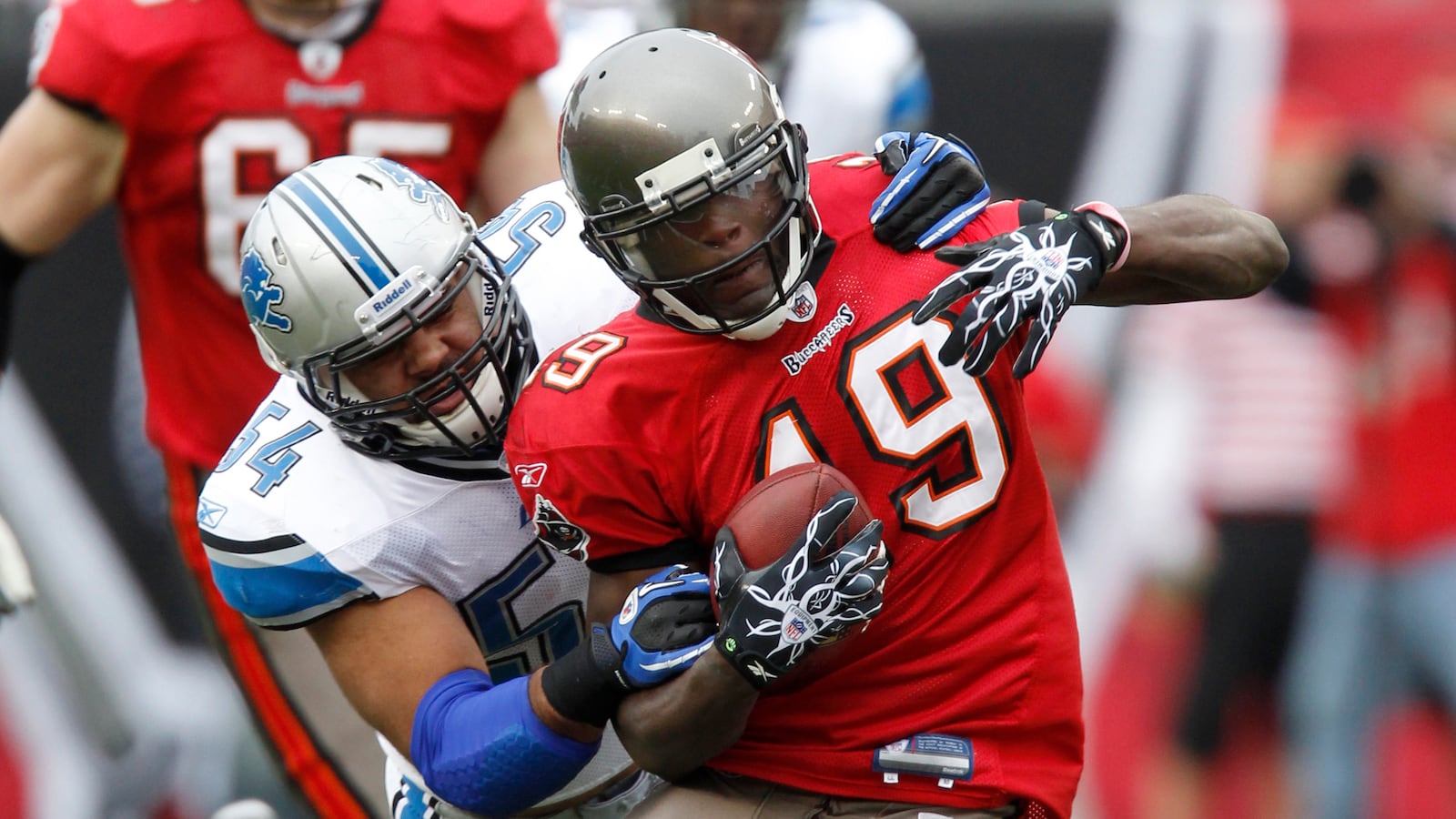 Detroit Lions linebacker DeAndre Levy (54) drags down Tampa Bay Buccaneers wide receiver Mike Williams (19) after a gain during the first half of their NFL football game in Tampa, Florida