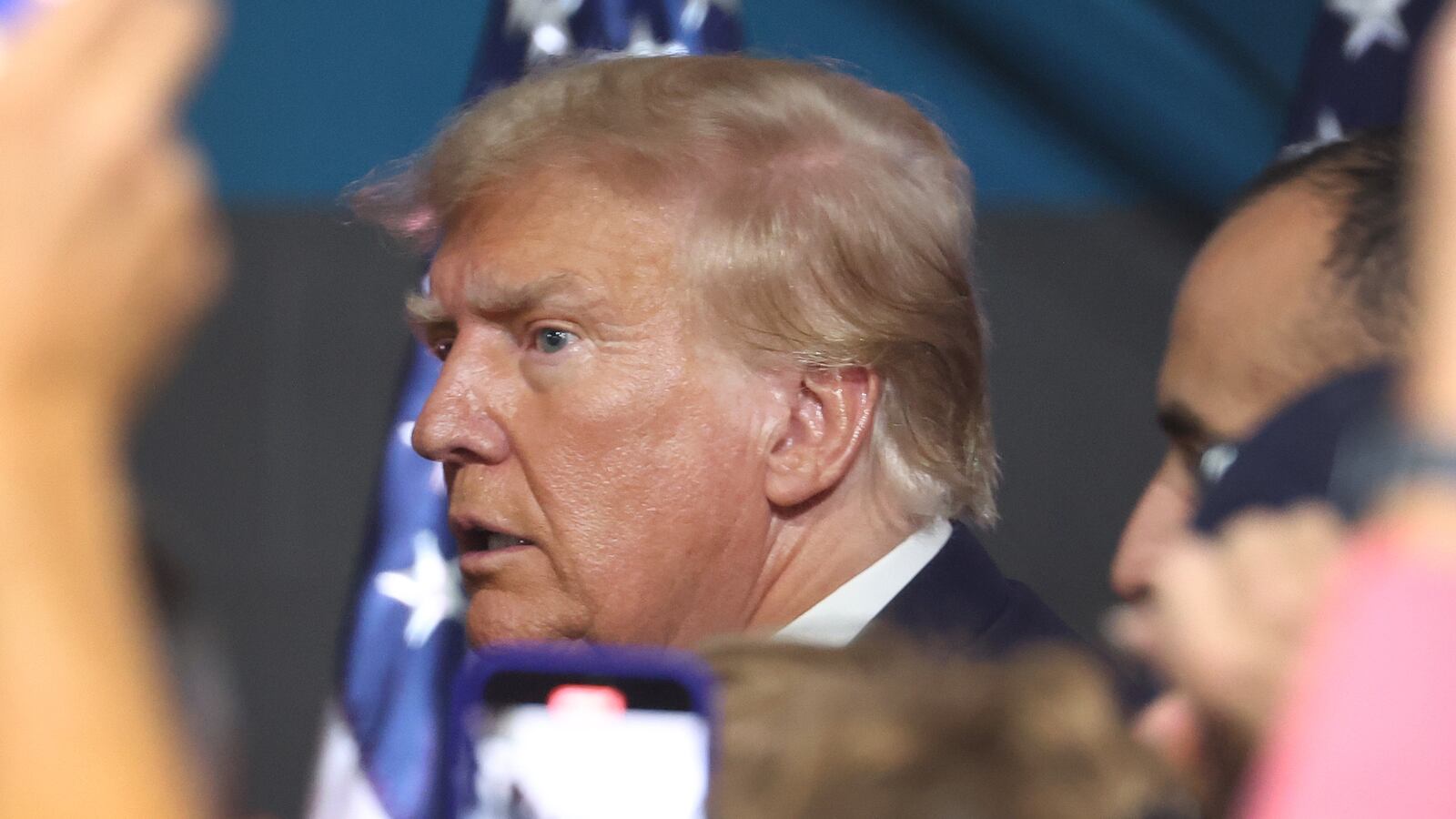Former U.S. President Donald Trump greets guests at a campaign rally.