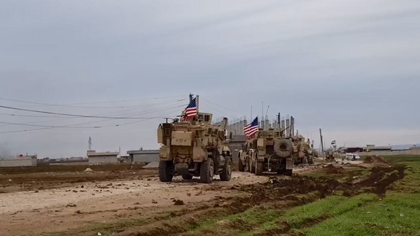 A convoy of U.S military vehicles moves in the village of Khirbet Amo, near Qamishli, Syria