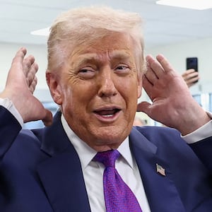 U.S. President Donald Trump checks his hair before sitting down for a podcast interview at the Varsity restaurant in Rome, Georgia, U.S., February 19, 2026.