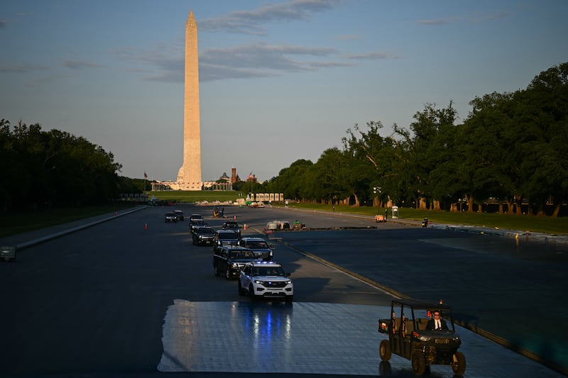 TOPSHOT - A convoy with US President Donald Trump is seen at the Lincoln Memorial Reflecting Pool in Washington, DC, on May 7, 2026. Workers have been resurfacing the bottom of Washington's famous Lincoln Memorial Reflecting Pool with "American flag blue"-colored material used in swimming pools, following an order by US President Donald Trump. (Photo by Kent NISHIMURA / AFP via Getty Images)