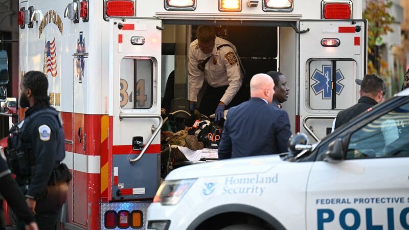 An unidentified man in military fatigues lies on a stretcher inside an ambulance Nov. 26, 2025 in downtown Washington, DC. Two National Guard soldiers were shot a few blocks from the White House, according to law enforcement.