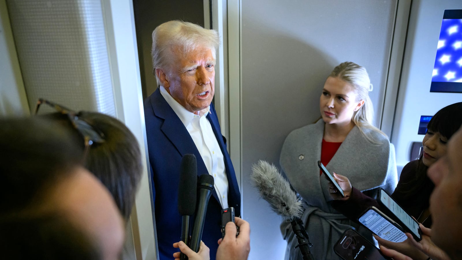 US President Donald Trump speaks with the press, alongside White House Press Secretary Karoline Leavitt, on board Air Force One after departing Las Vegas, Nevada, en route to Miami, Florida on January 25, 2025.