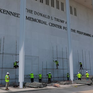 WASHINGTON, DC - JUNE 12: Construction workers build scaffolding near the sign for the Donald J. Trump and John F. Kennedy Memorial Center for the Performing Arts on June 12, 2026 in Washington, DC. The Kennedy Center board voted to seek an emergency appeal to block a court order requiring the removal of President Trump's name from the Kennedy Center. (Photo by Anna Moneymaker/Getty Images)