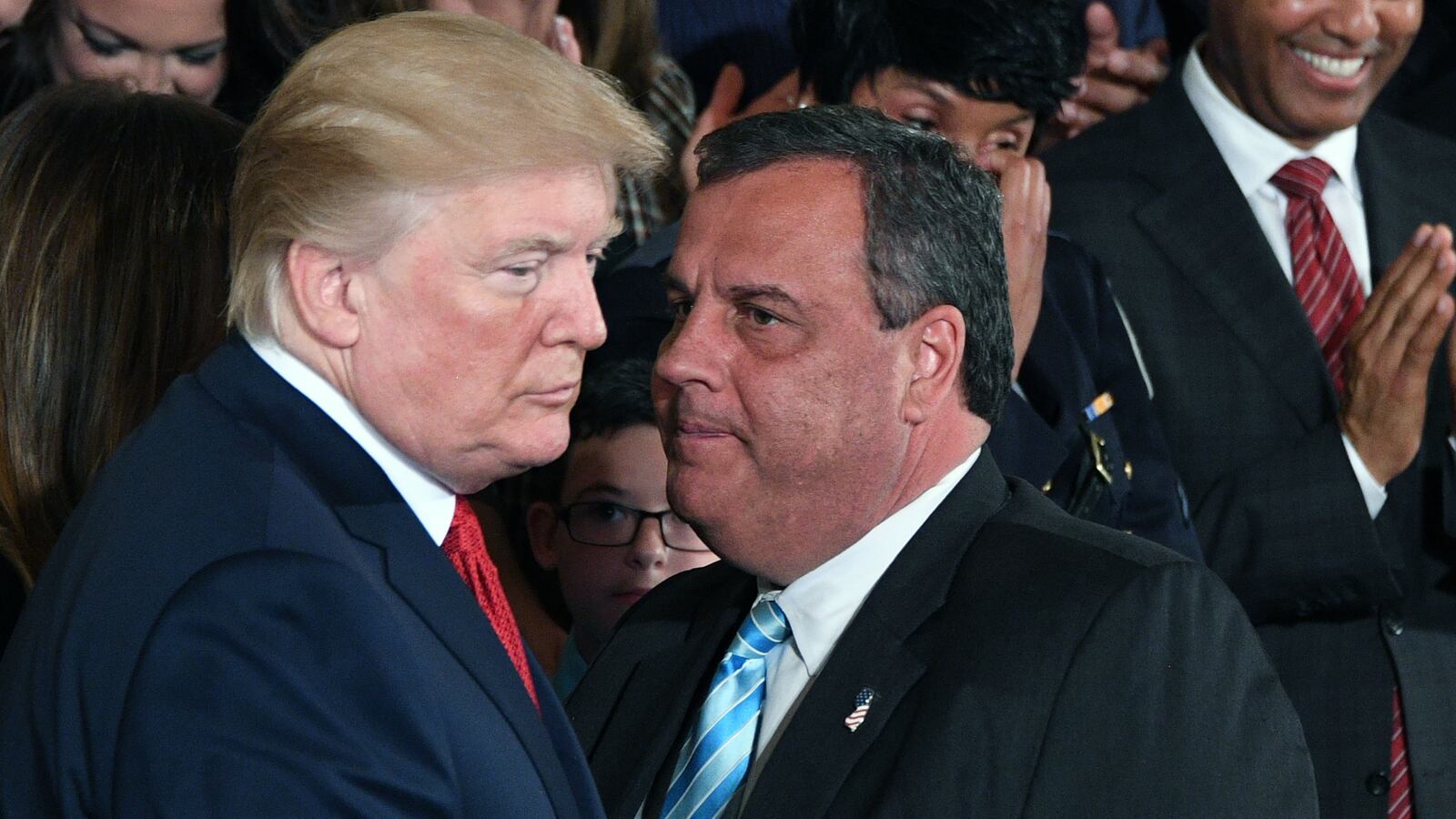 Governor Chris Christie(R-NJ) speaks with US President Donald Trump(L) after he delivered remarks on combating drug demand and the opioid crisis on October 26, 2017 in the East Room of the White House in Washington, DC.