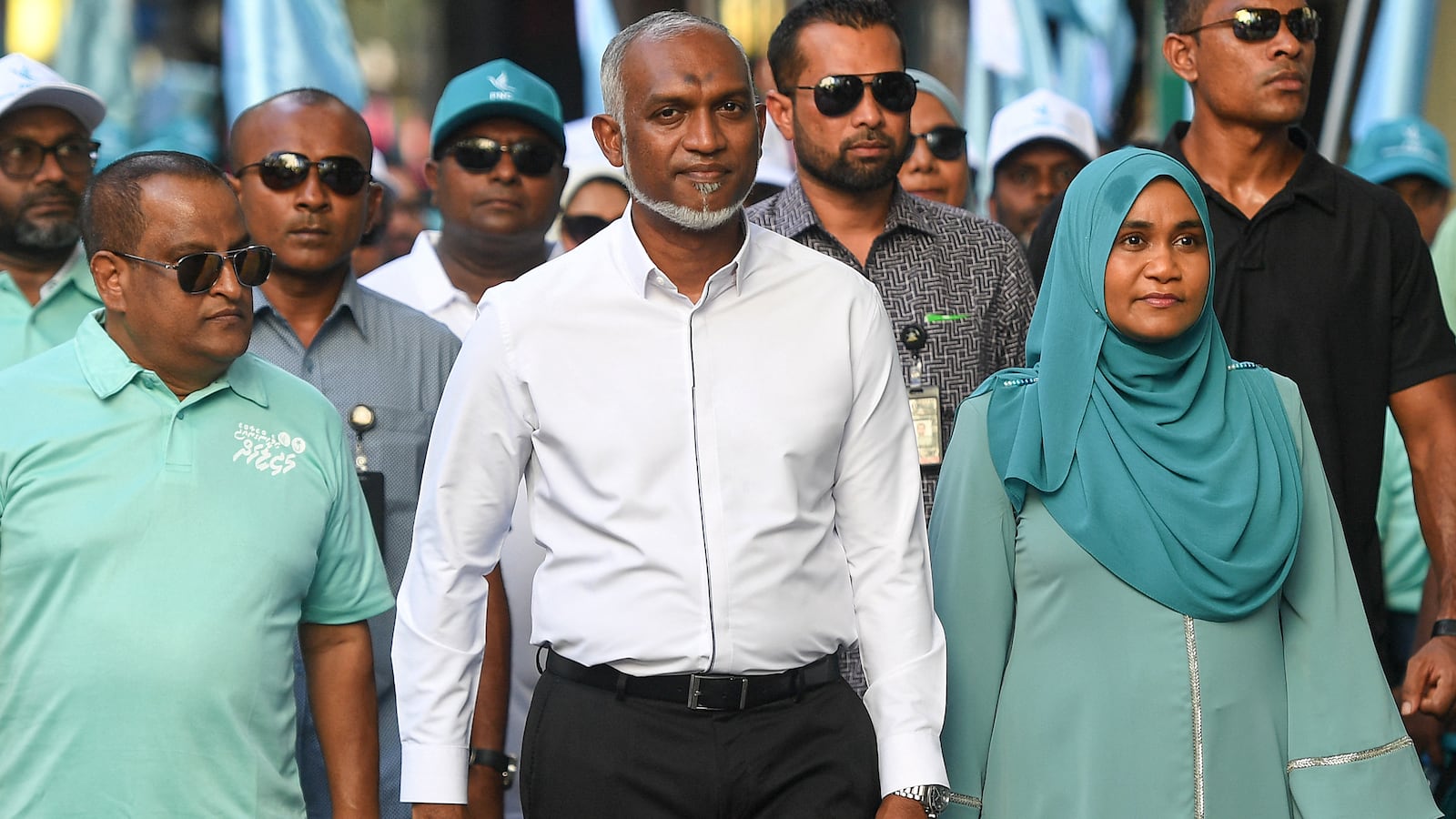 Maldives' President Mohamed Muizzu (C) along with his supporters take part in an election campaign rally on the eve of the country's parliamentary election, in Male on April 20, 2024.