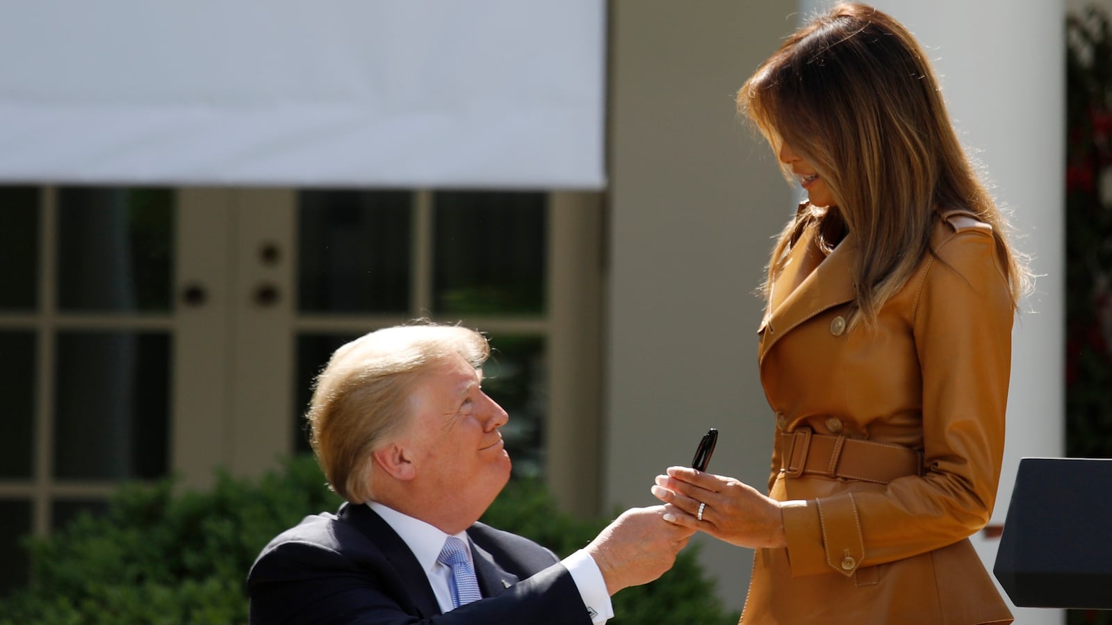 First lady Melania Trump receives a pen from President Donald Trump after he signed the Be Best initiatives proclamation in the Rose Garden of the White House in Washington, D.C., May 7, 2018.