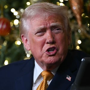 US President Donald Trump participates in NORAD Santa tracker phone calls, on Christmas Eve, from the Mar-a-lago club in Palm Beach, Florida, on December 24, 2025. (Photo by ANDREW CABALLERO-REYNOLDS / AFP via Getty Images)