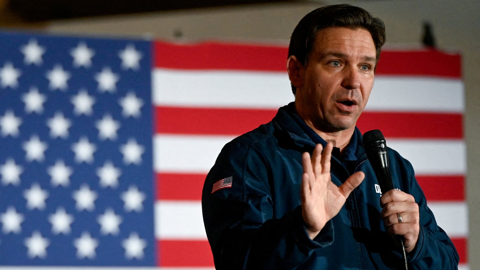 Republican presidential candidate and Florida Governor Ron DeSantis gestures as he speaks at a campaign event at The Thunderdome in Newton, Iowa