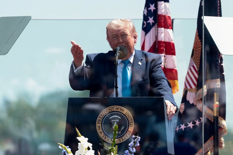 U.S. President Donald Trump stands behind protective glass as he delivers the commencement address at the U.S. Coast Guard Academy in New London, Connecticut, U.S., May 20, 2026.