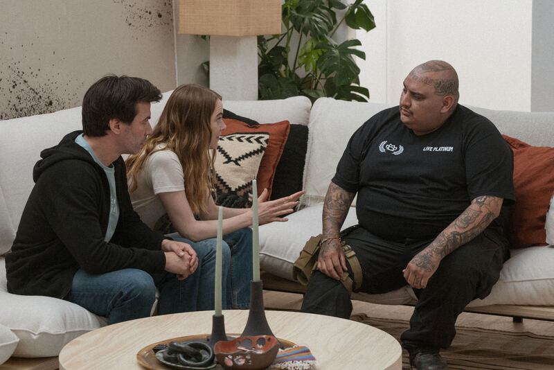 Nathan Fielder and Emma Stone sit on a couch in a still from ‘The Curse’