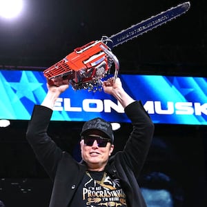 Elon Musk holds a chainsaw reading "Long live freedom, damn it" during the annual Conservative Political Action Conference (CPAC) at the Gaylord National Resort & Convention Center at National Harbor in Oxon Hill, Maryland, on February 20, 2025.