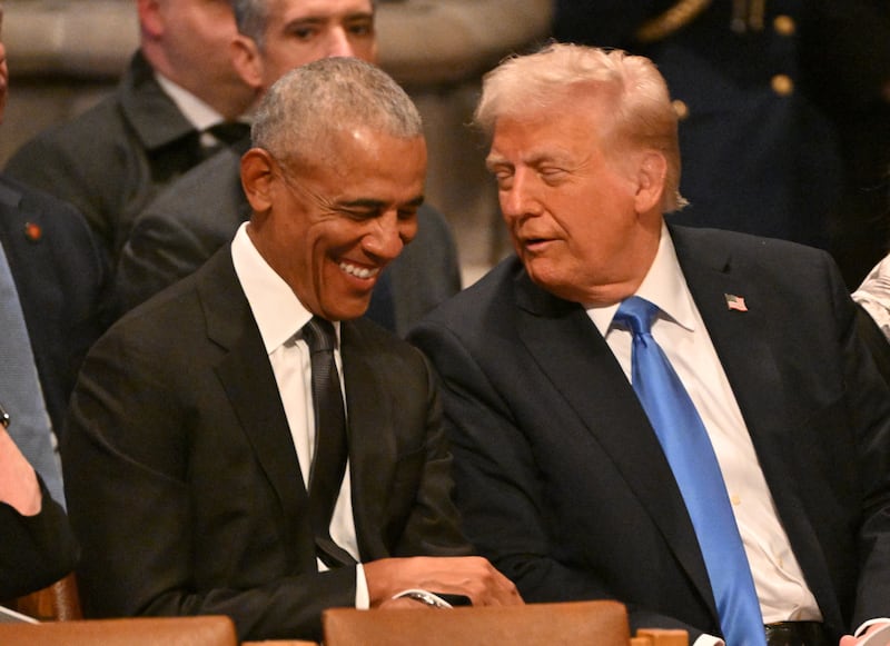 Former President Barack Obama speaks with President-elect Donald Trump before the State Funeral Service for former President Jimmy Carter at the Washington National Cathedral in Washington, DC, on January 9, 2025.