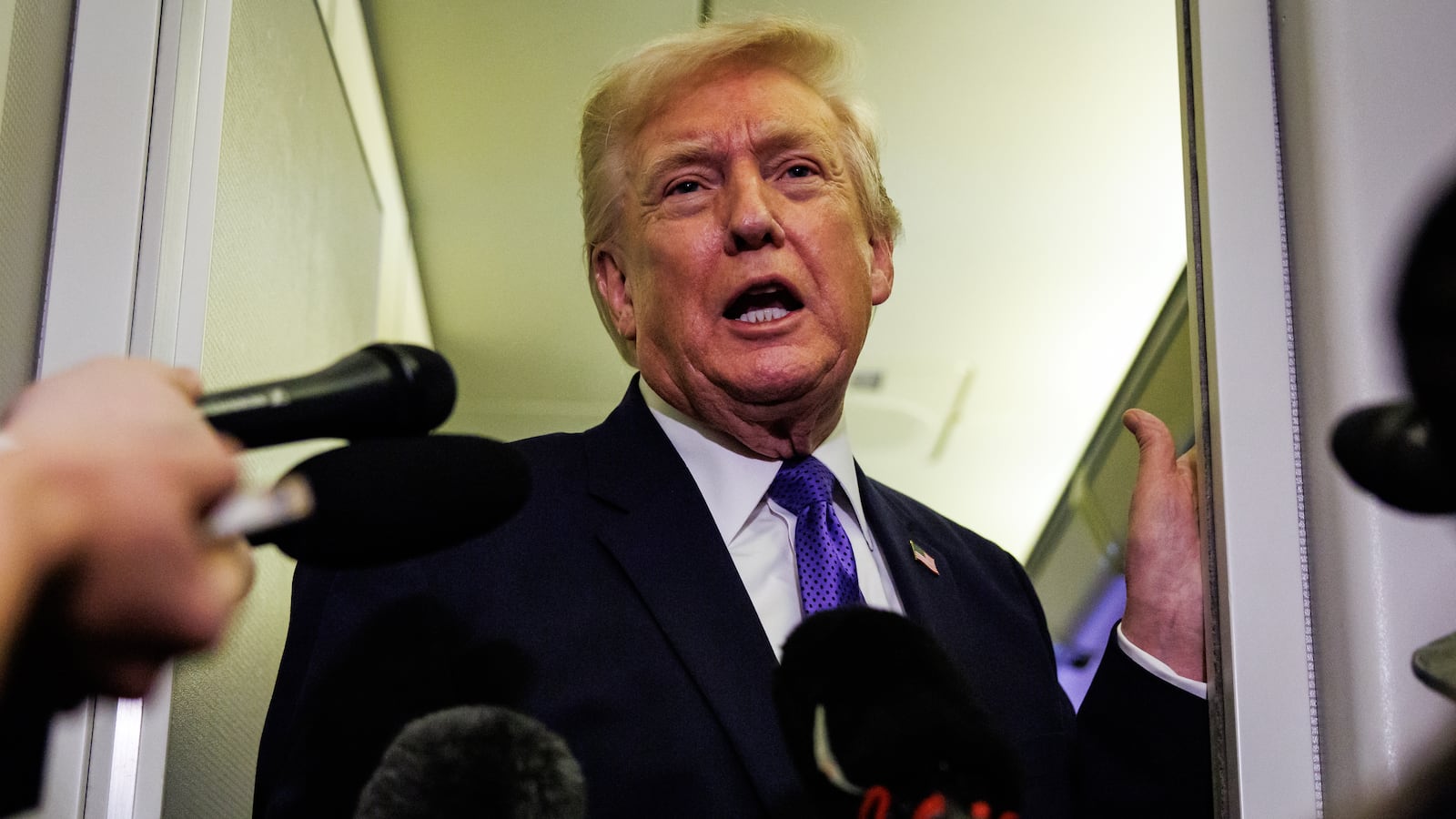 IN FLIGHT - FEBRUARY 06: U.S. President Donald Trump gaggles with reporters while aboard Air Force One on February 6, 2026 en route to Palm Beach, Florida. The President is spending the weekend at Mar-a-Lago, his private club. (Photo by Samuel Corum/Getty Images)