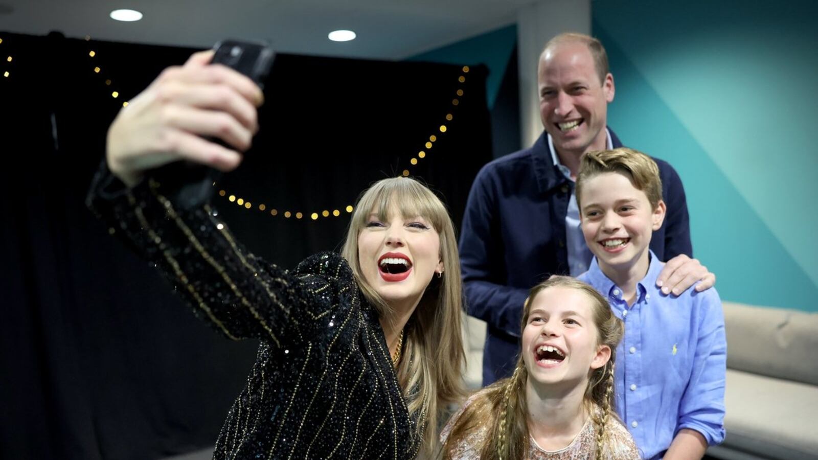 Taylor Swift takes a selfie with Prince William and his children Princess Charlotte and Prince George.