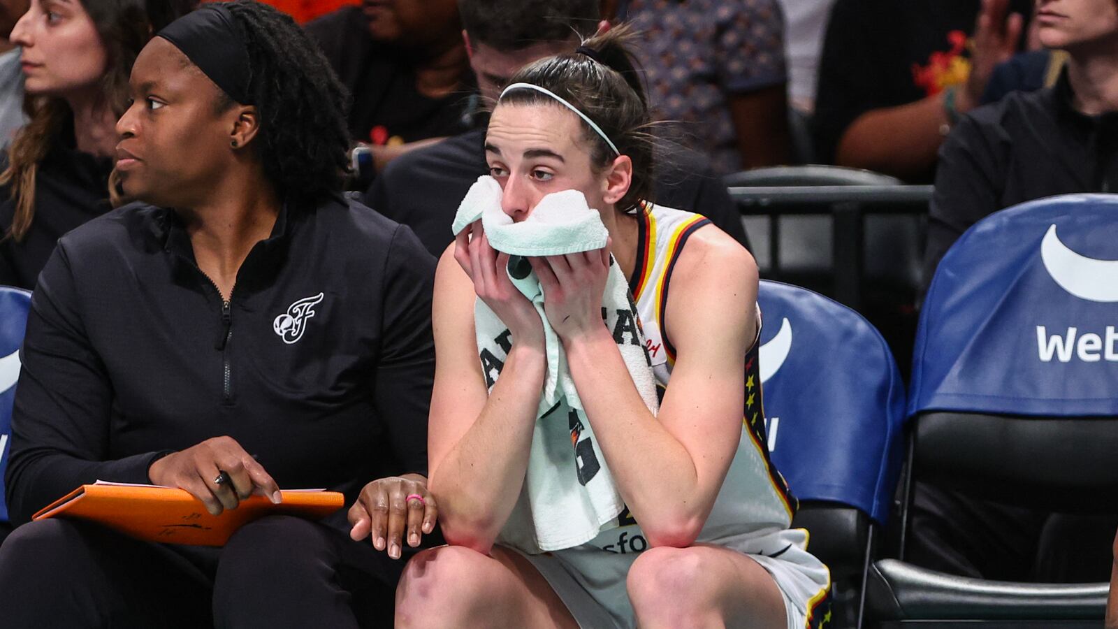 Indiana Fever guard Caitlin Clark (22) watches from the bench.